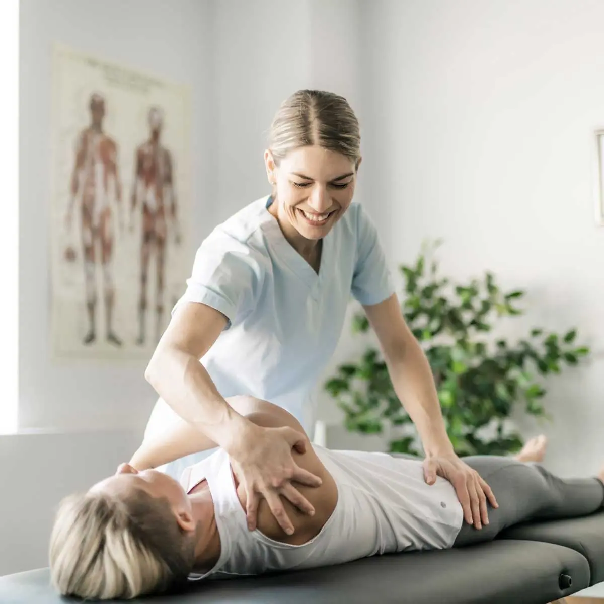 Chiropractor helping patient with back pain